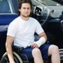 a young man in a wheelchair with a cast on one arm