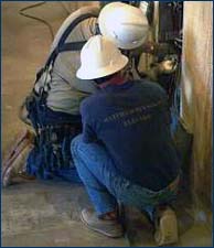 kneeling electrical workers